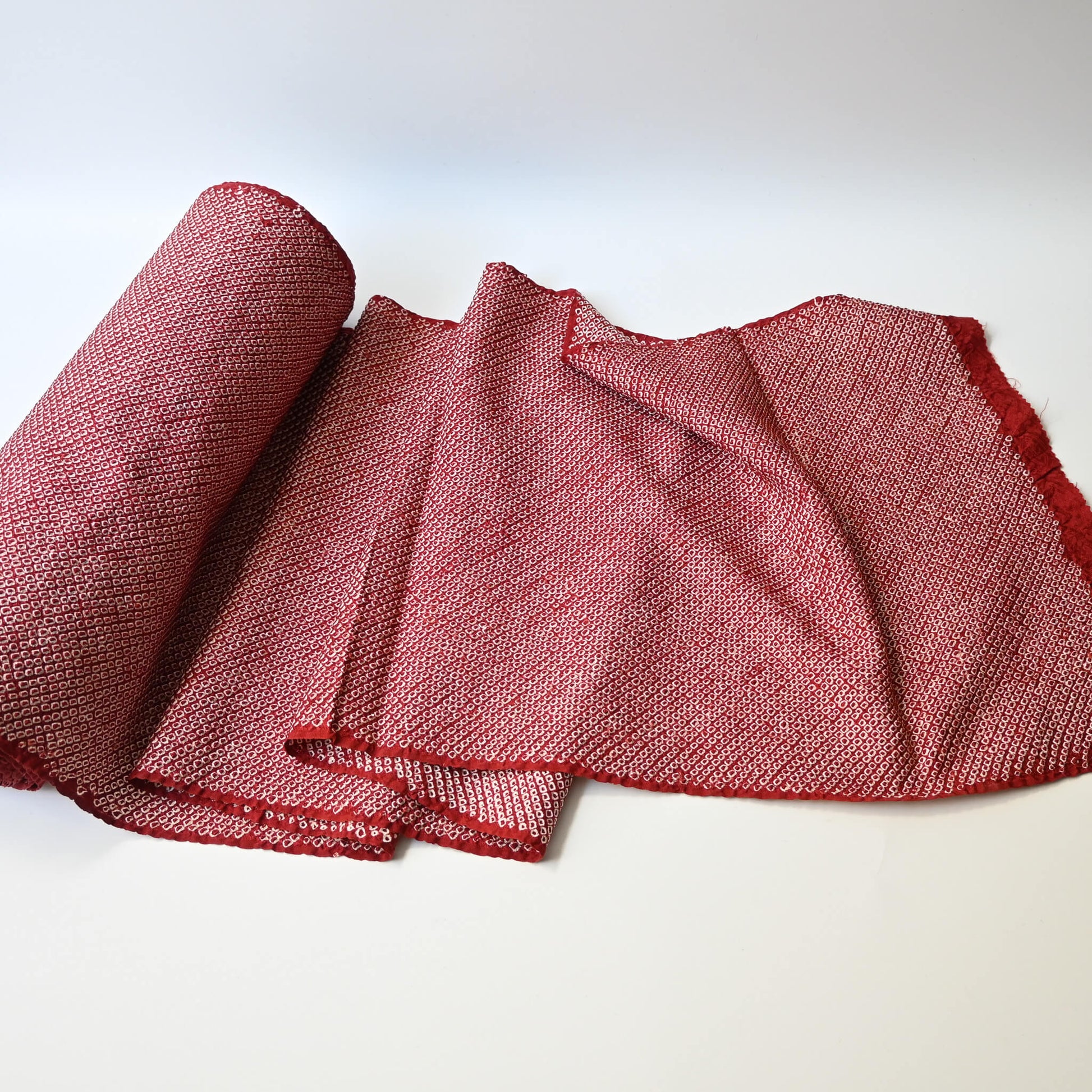 Full view of vintage silk kanoko shibori kimono fabric in rich burgundy red.