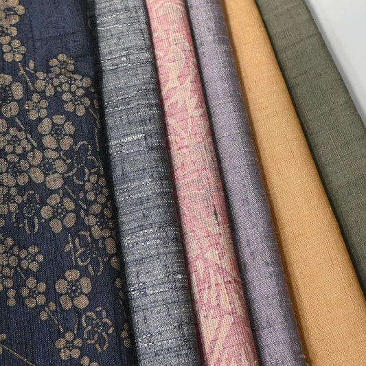 Close-up view of set of six vintage tsumugi silk kimono fabric pieces in softly muted tones, ideal for any craft project.