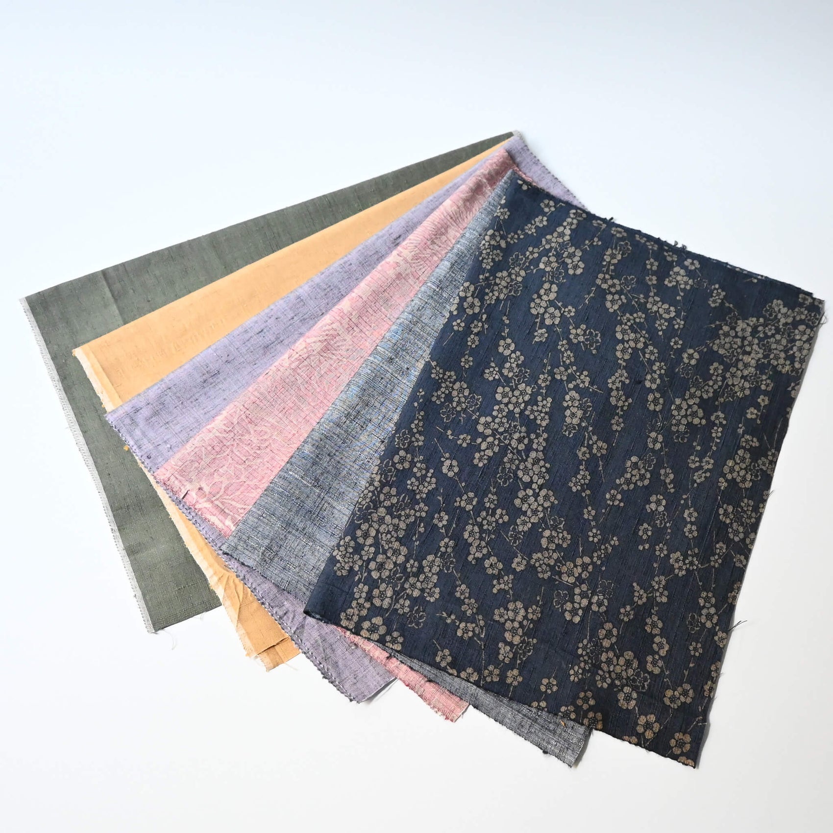 Set of six vintage tsumugi silk kimono fabric pieces in softly muted tones, ideal for any craft project.