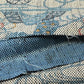 Close-up view of vintage silk kimono fabric piece with katazome dyed tea ceremony utensil motif.