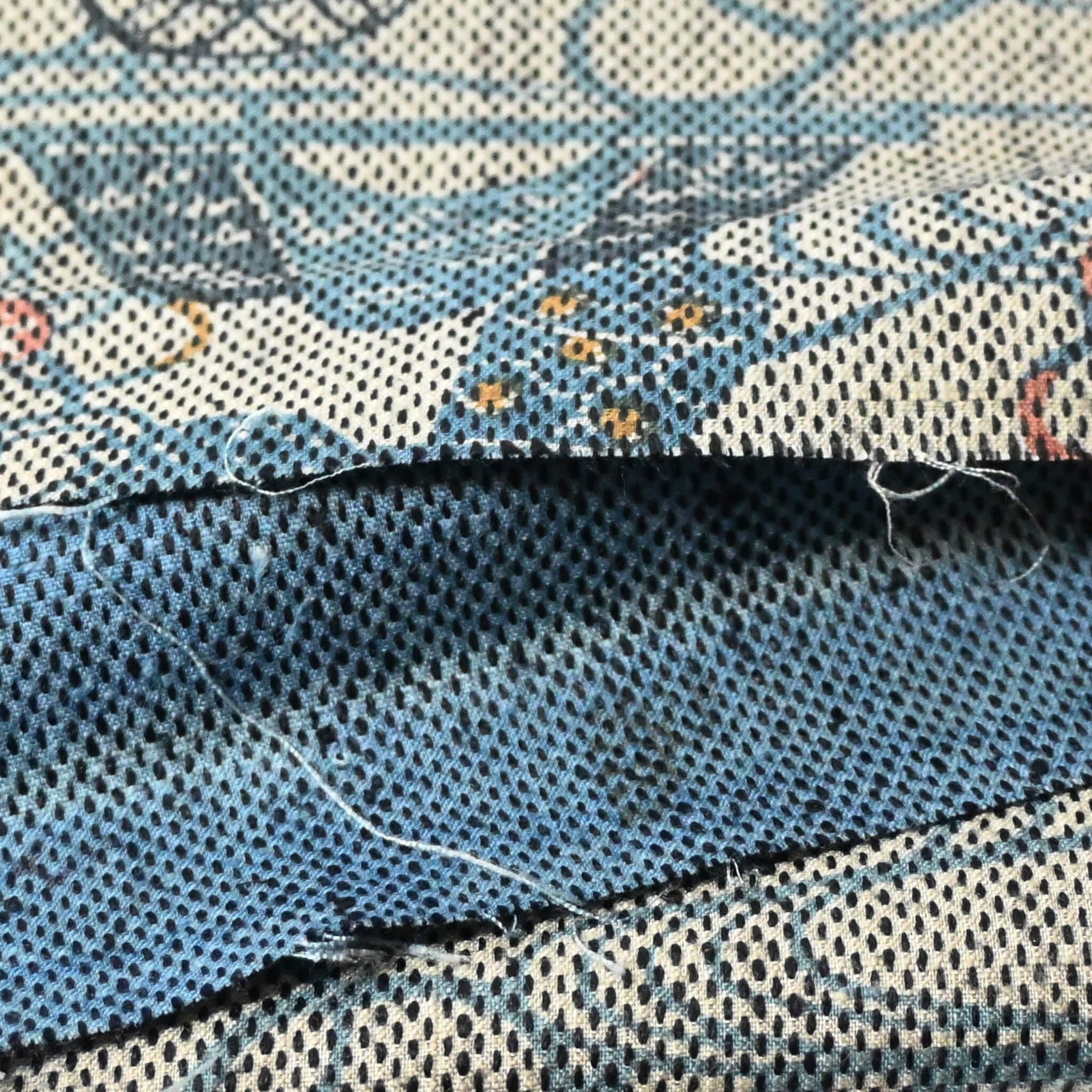 Close-up view of vintage silk kimono fabric piece with katazome dyed tea ceremony utensil motif.