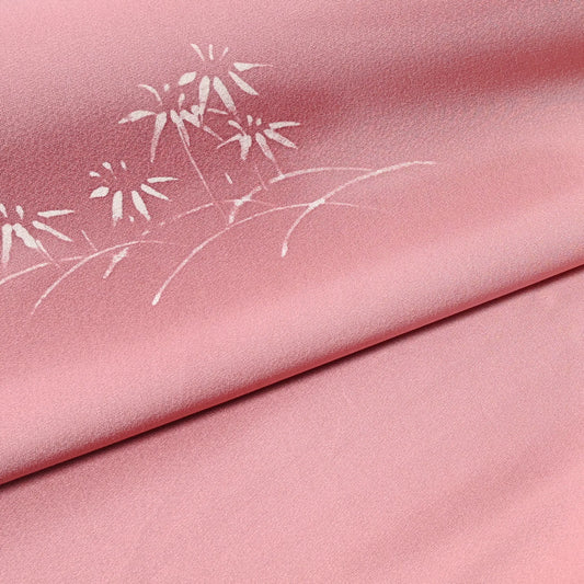 Close-up view of vintage Japanese silk kimono fabric in pale purple with a pink tone, featuring a bamboo motif.