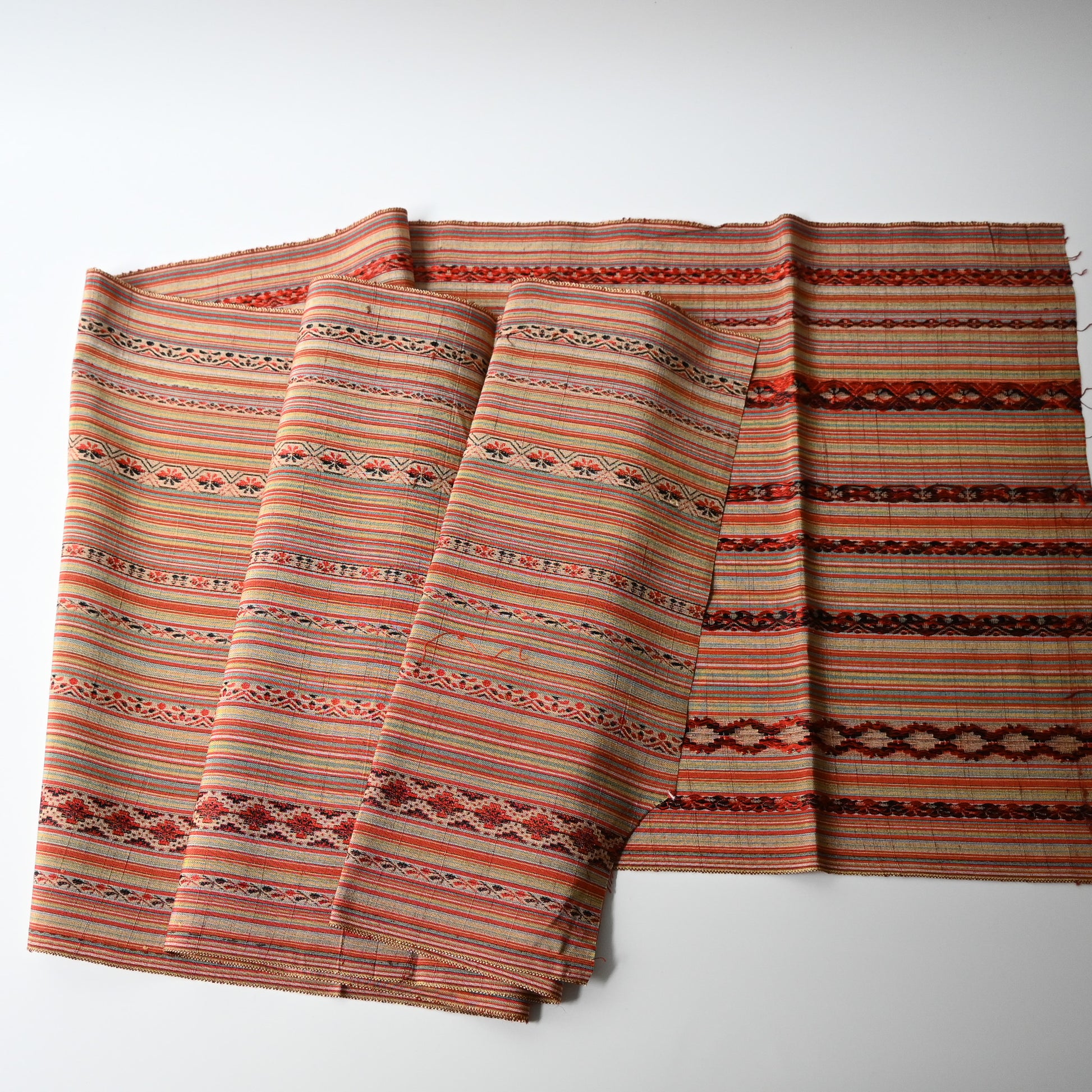 Full view of vintage silk kimono fabric with an unusual pattern, resembling Eastern European folk textiles.