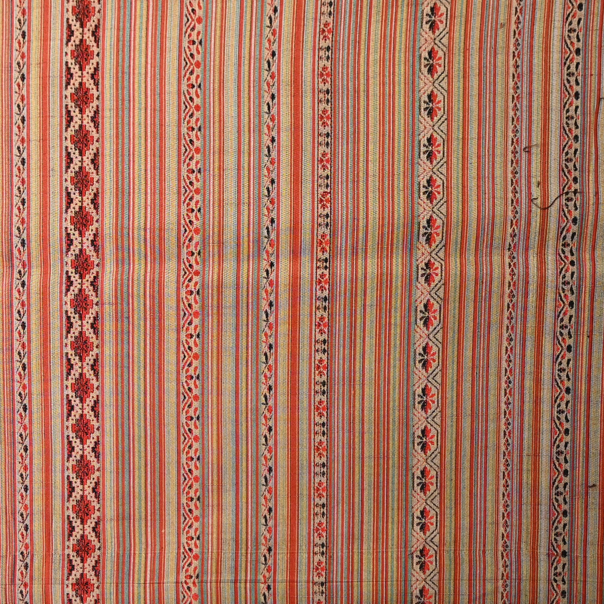 Detailed view of vintage silk kimono fabric with an unusual pattern, resembling Eastern European folk textiles.