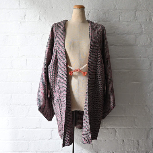 Vintage women's silk textured all-over shibori haori in black and red-pink. 