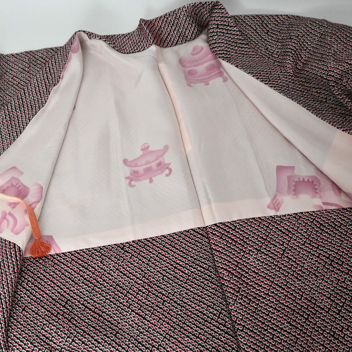 Vintage women's silk textured all-over shibori haori in black and red-pink. 