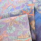 Detailed view of vintage silk wool blend floral kimono fabric, beautiful textured surface.