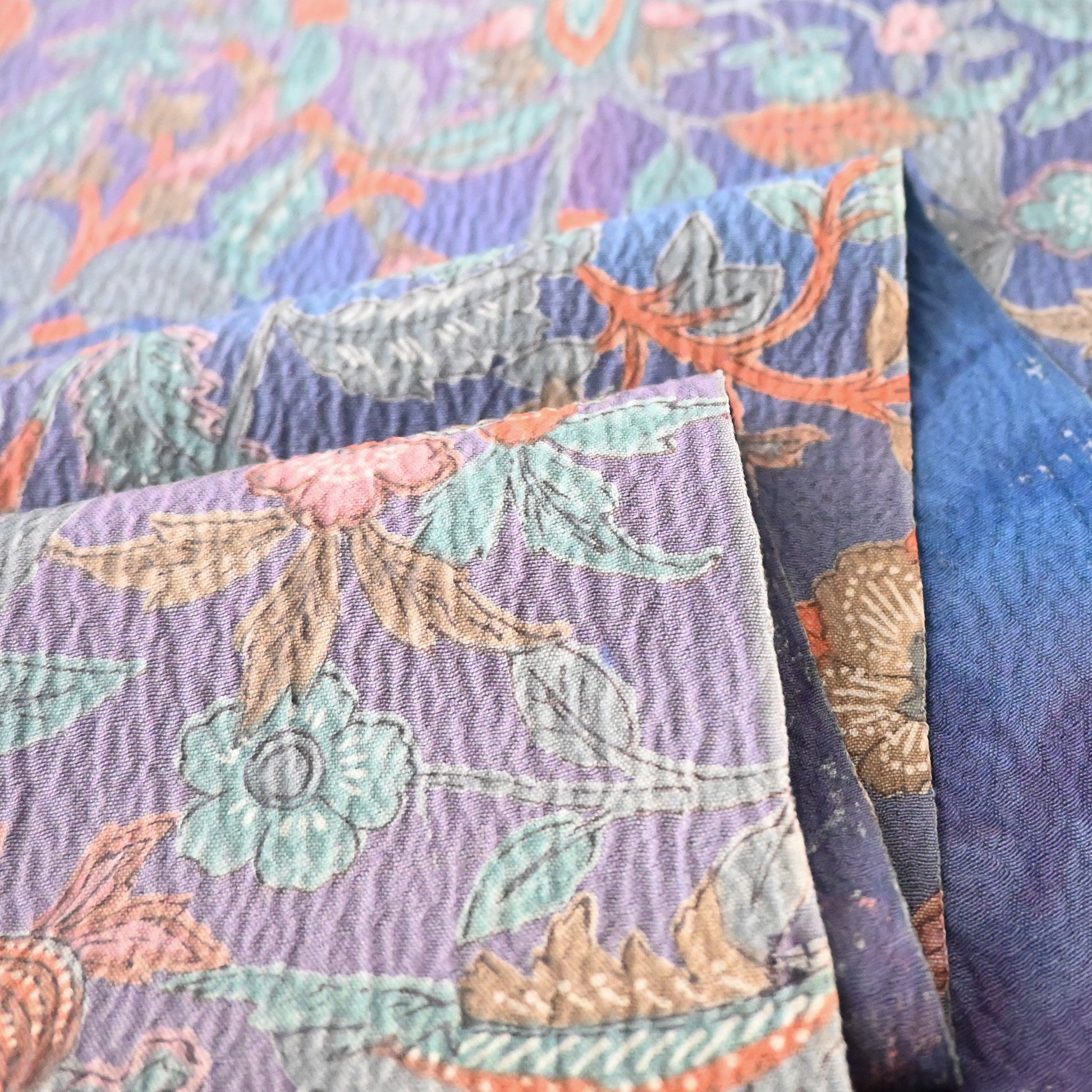 Detailed view of vintage silk wool blend floral kimono fabric, beautiful textured surface.