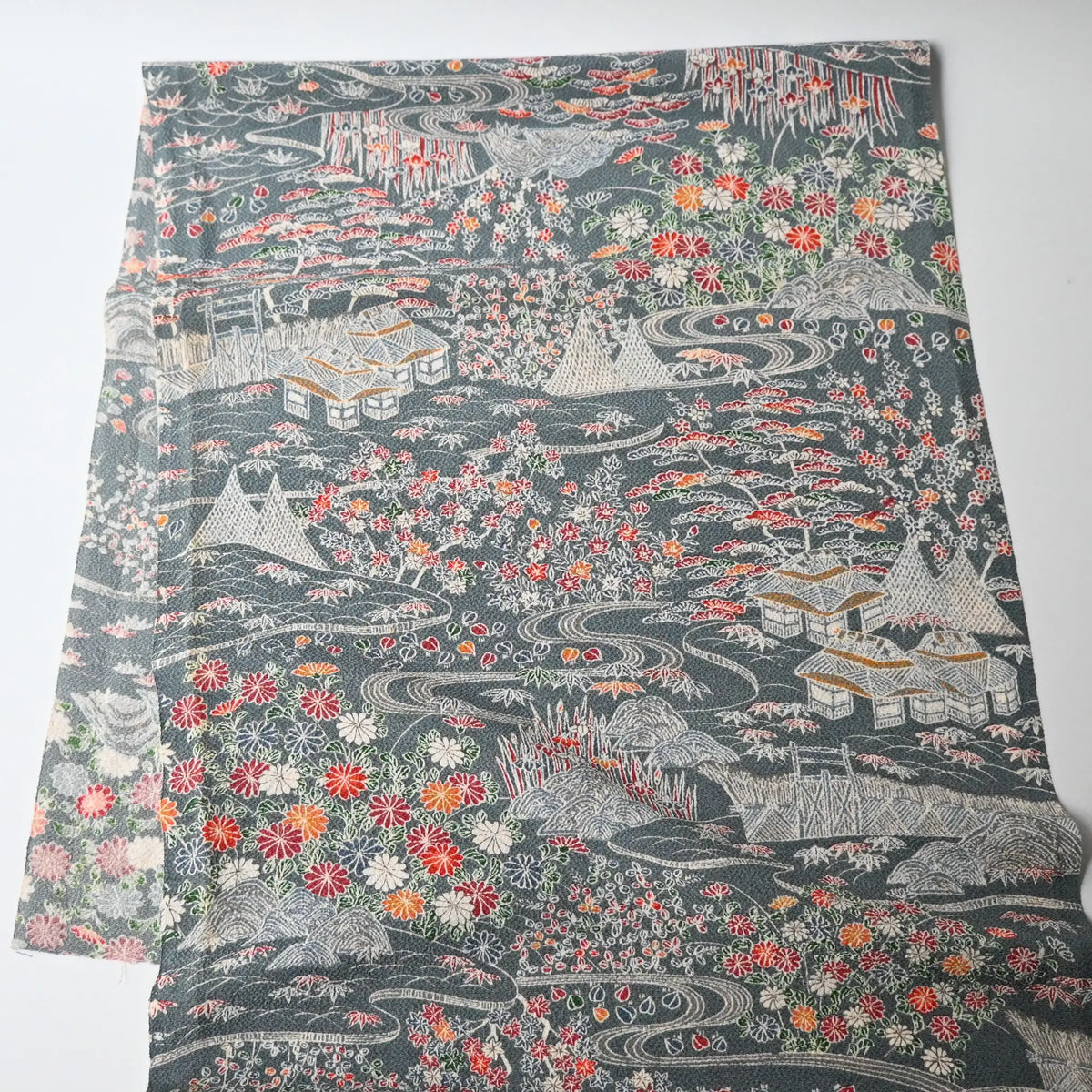 Full view of vintage Japanese heavy silk crepe Chirimen kimono fabric in slate grey with gorgeous floral pattern.
