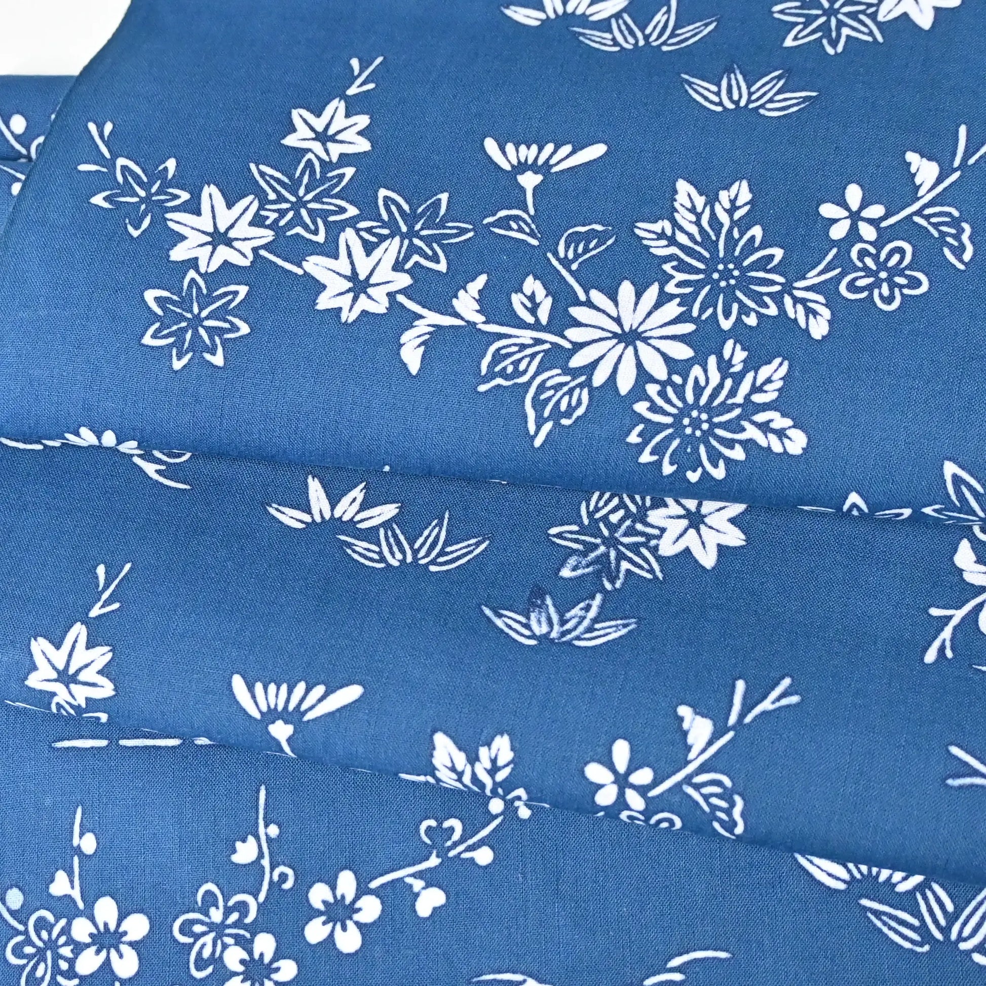 Vintage traditional Japanese yukata cotton fabric with seasonal flowers in soft blue.