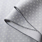 Close-up view of vintage tsumugi silk kimono fabric sold by the metre in soft grey lilac tone with cross motif.