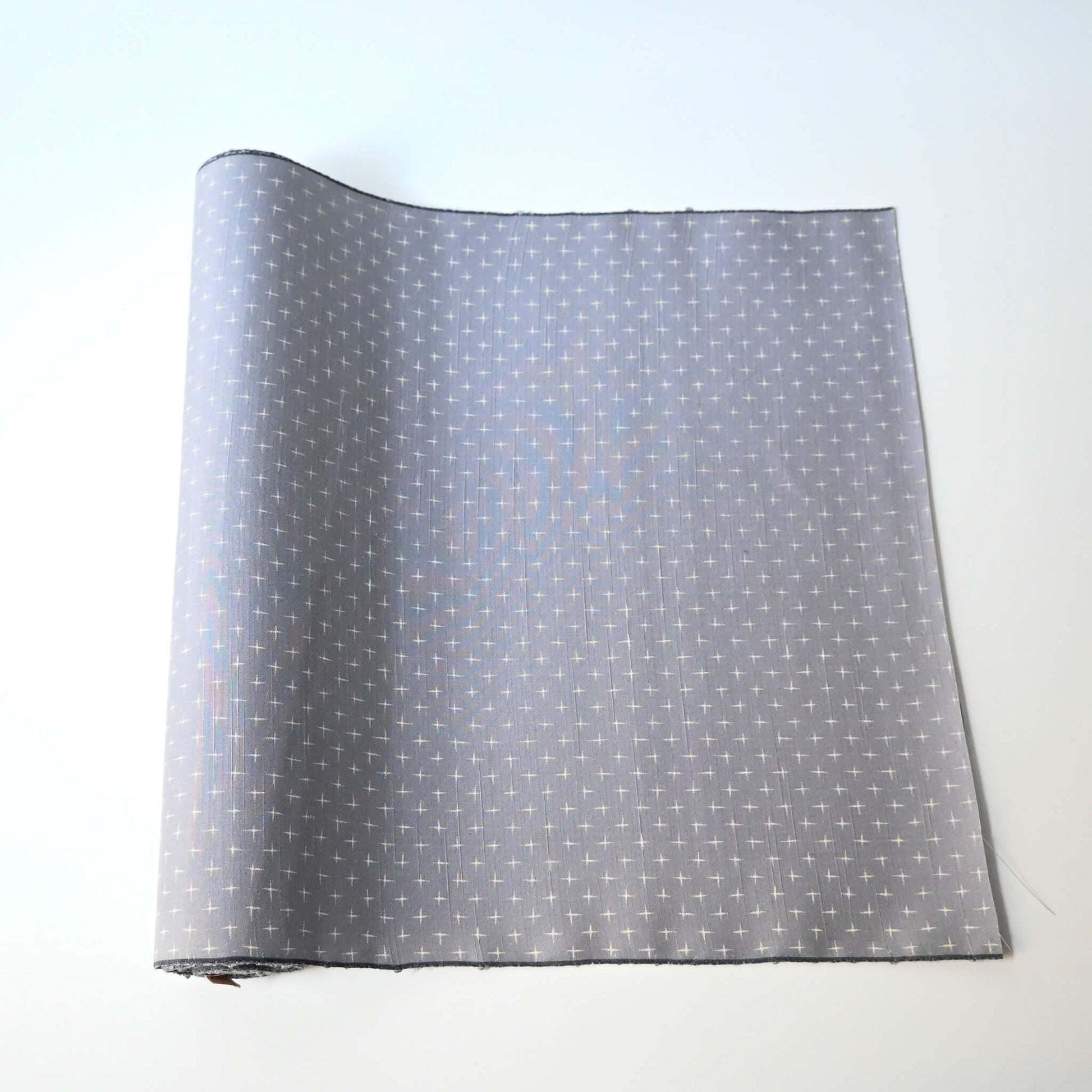 Vintage tsumugi silk kimono fabric sold by the metre in soft grey lilac tone with cross motif.
