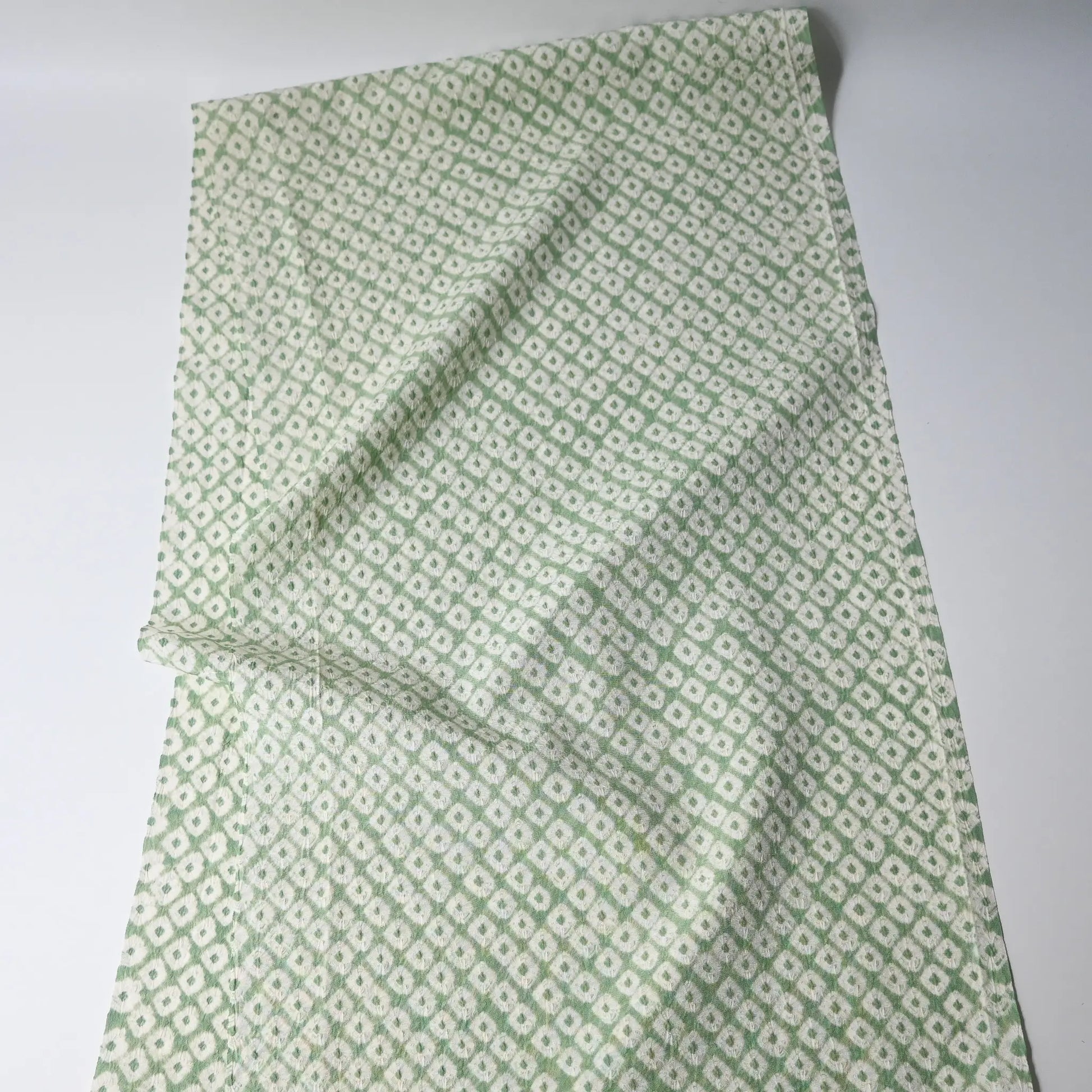 Full view of vintage soft lime green silk shibori kimono fabric piece.