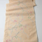 Full view of vintage soft yellow tsumugi kimono silk fabric piece with plum blossom pattern.