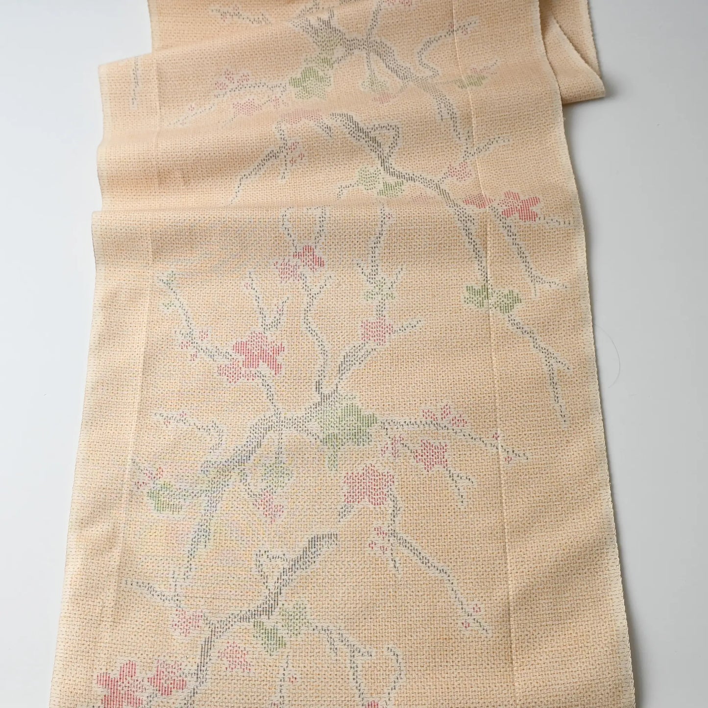 Full view of vintage soft yellow tsumugi kimono silk fabric piece with plum blossom pattern.