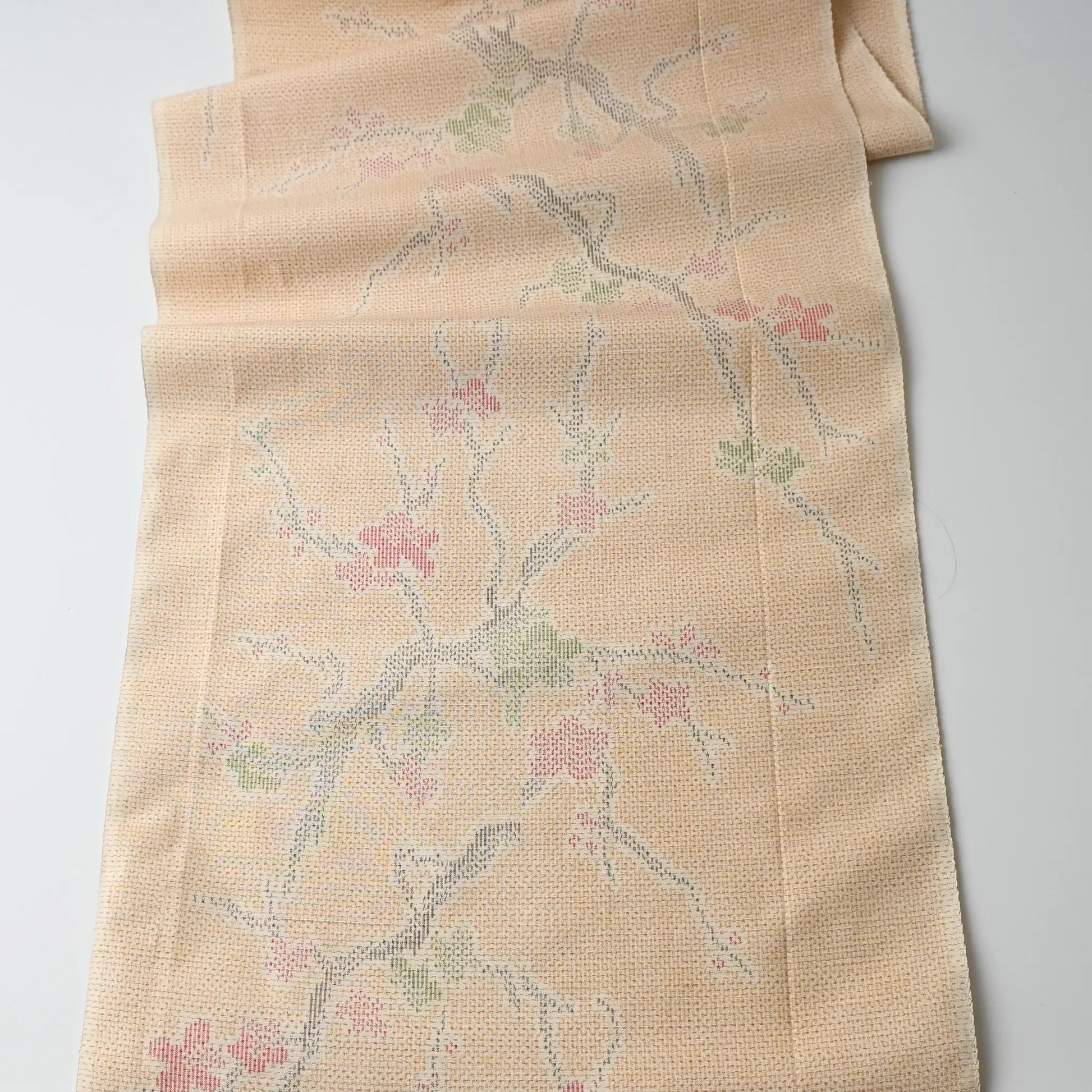 Full view of vintage soft yellow tsumugi kimono silk fabric piece with plum blossom pattern.