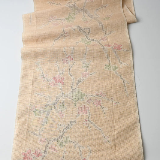 Full view of vintage soft yellow tsumugi kimono silk fabric piece with plum blossom pattern.