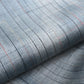 close-up of vintage Japanese tsumugi silk kimono fabric roll in stone blue with sheen.