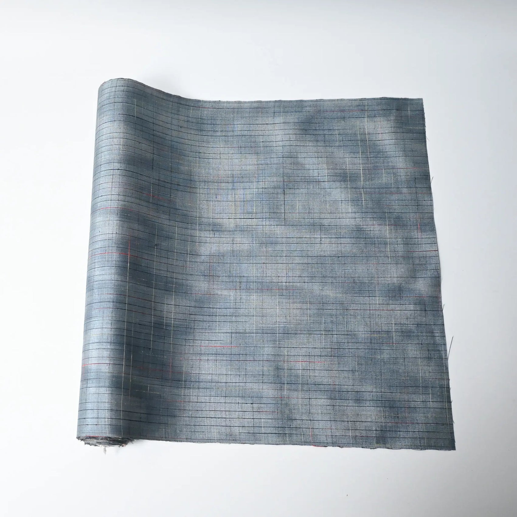 Vintage Japanese tsumugi silk kimono fabric roll in stone blue with sheen.