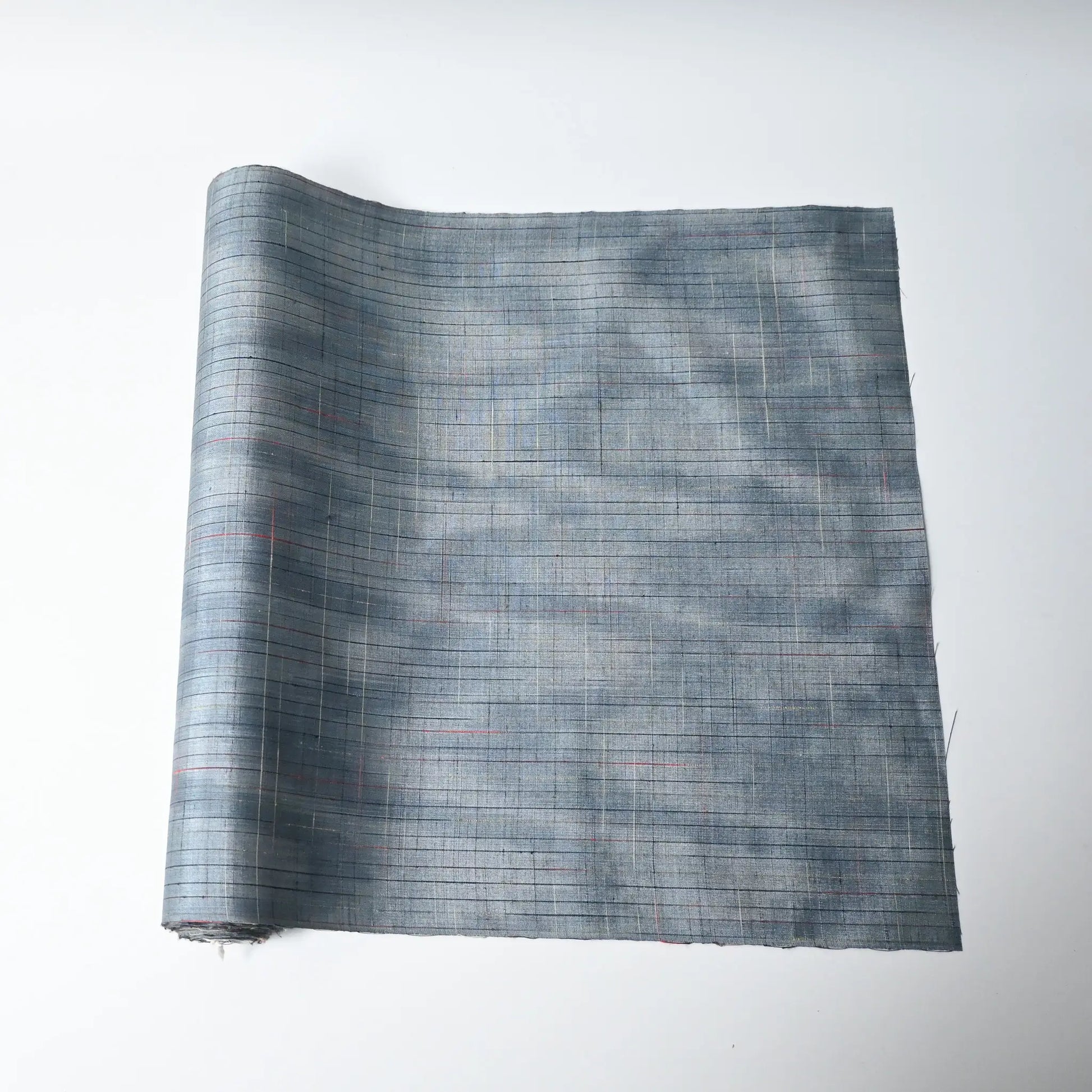 Vintage Japanese tsumugi silk kimono fabric roll in stone blue with sheen.