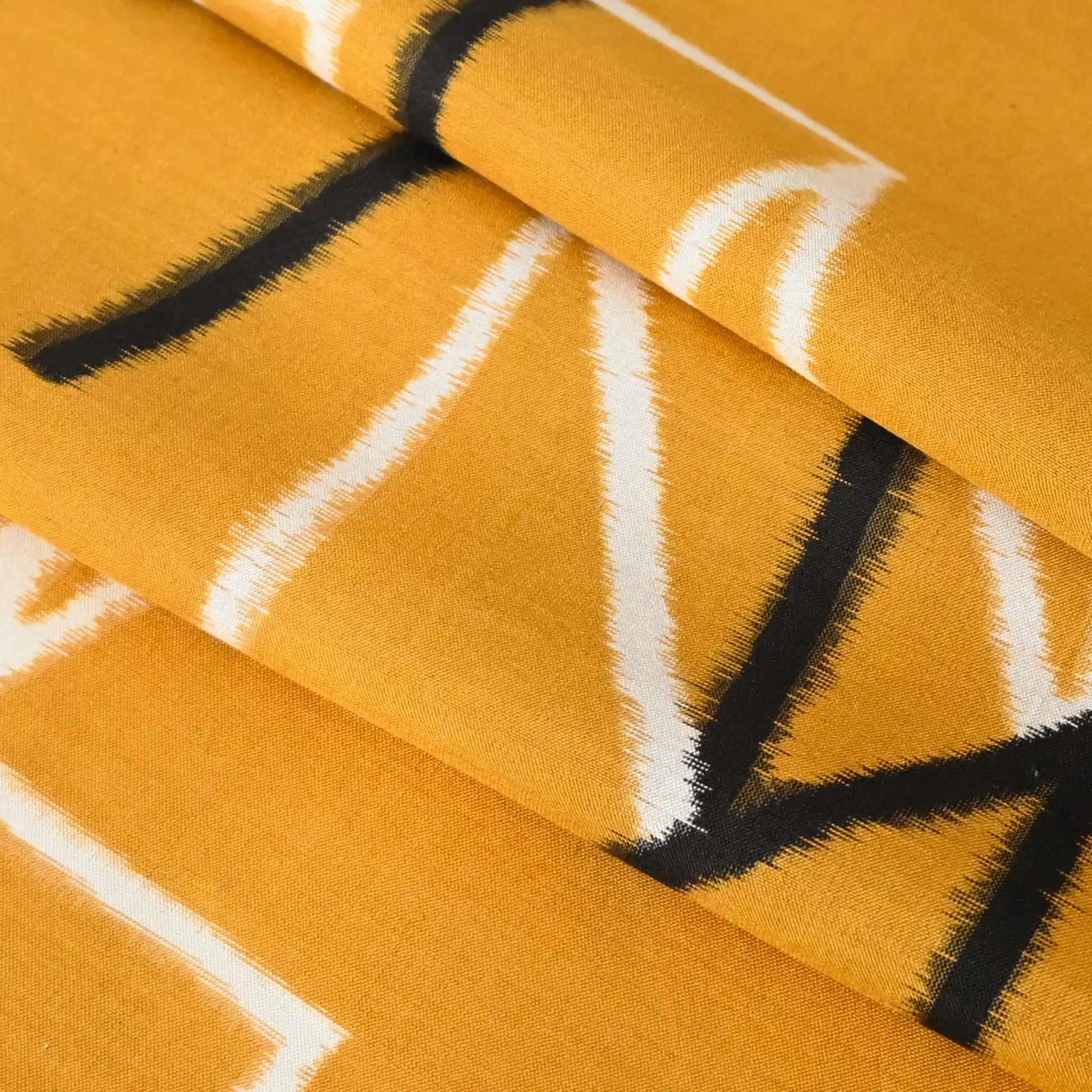 Detailed view of vintage Japanese Meisen kimono silk piece in striking yellow with black and white line motif from the mid-20th century.