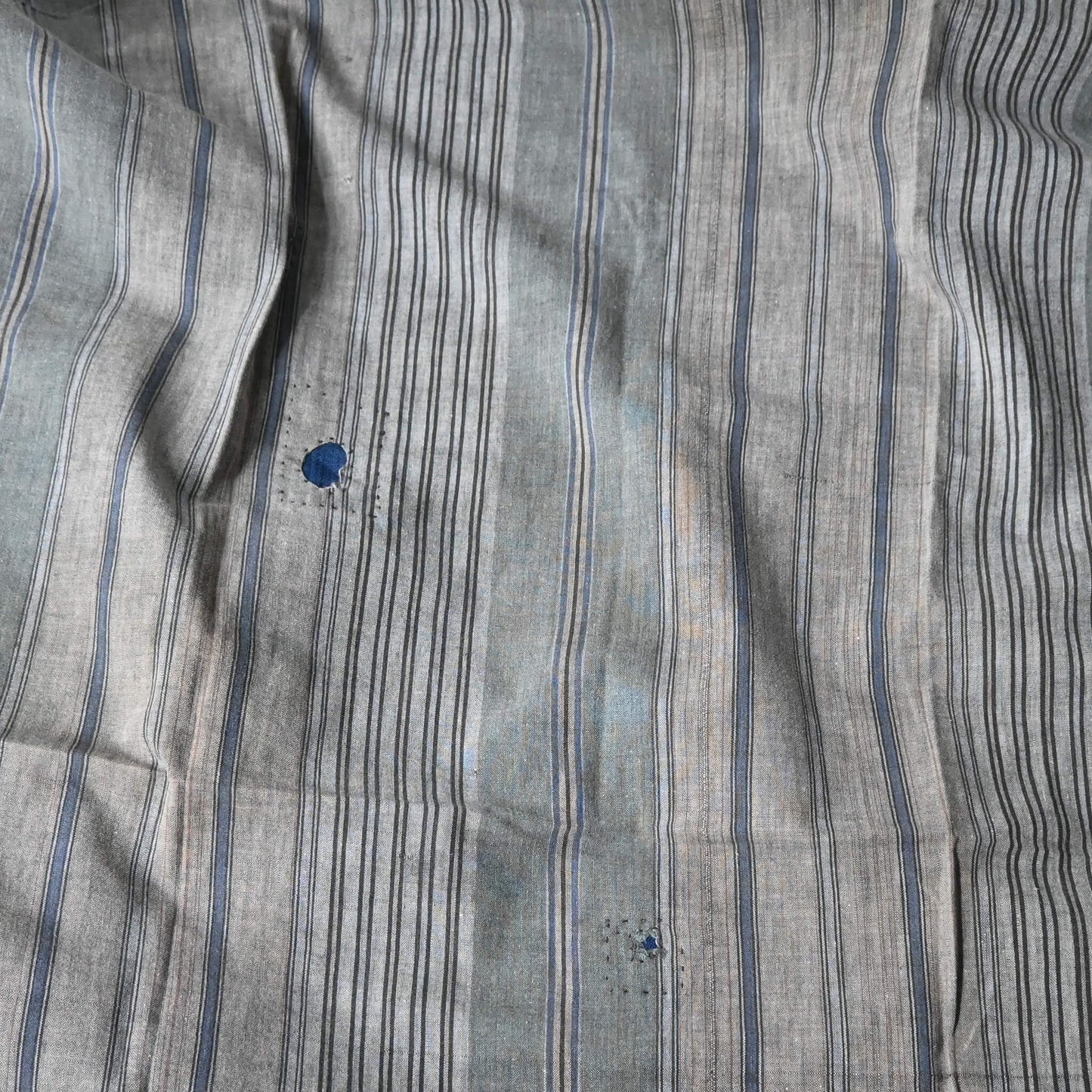 Detailed view of vintage stripe cotton furoshiki in soft grey tone, with some mended patches with indigo cottons.