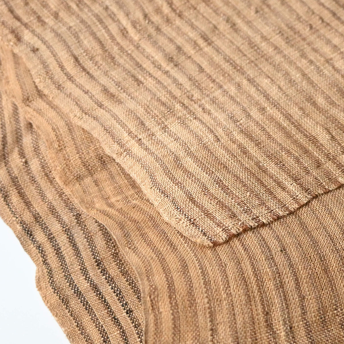 Close-up view of vintage collectable bashofu banana fibre textile, natural brown stripe.