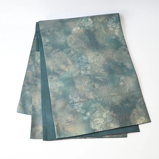 Full view of vintage muted teal blue silk Fukure-ori obi with grape vine motif.