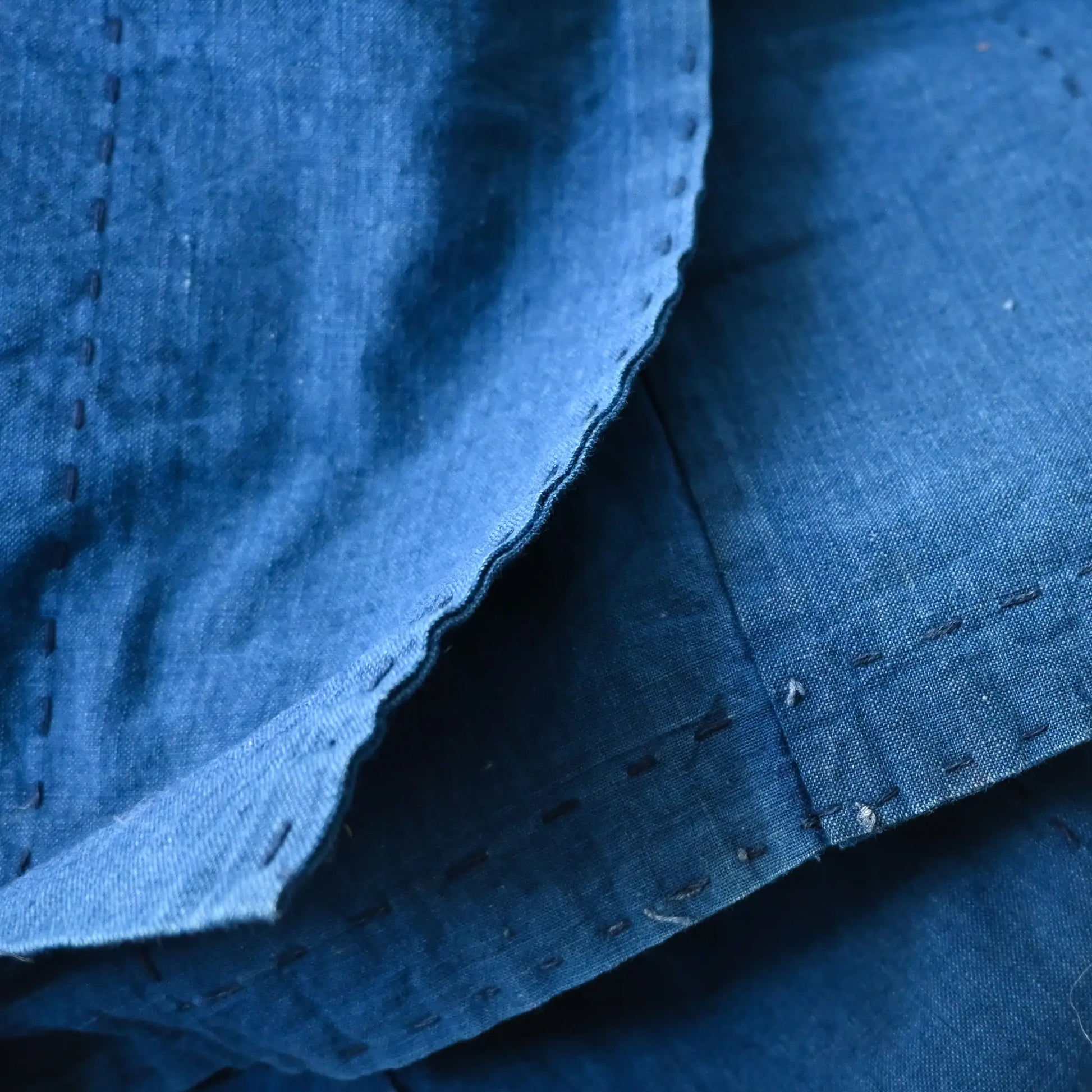 Close-up view of vintage Japanese three-panel indigo dyed cotton throw with sashiko stitching.