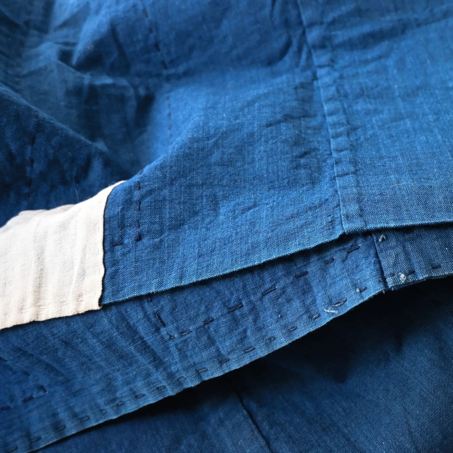 Detailed view of vintage Japanese three-panel indigo dyed cotton throw with sashiko stitching.