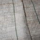 Detail of vintage three-panel mosquito net kaya hemp, natural with green stripes design.