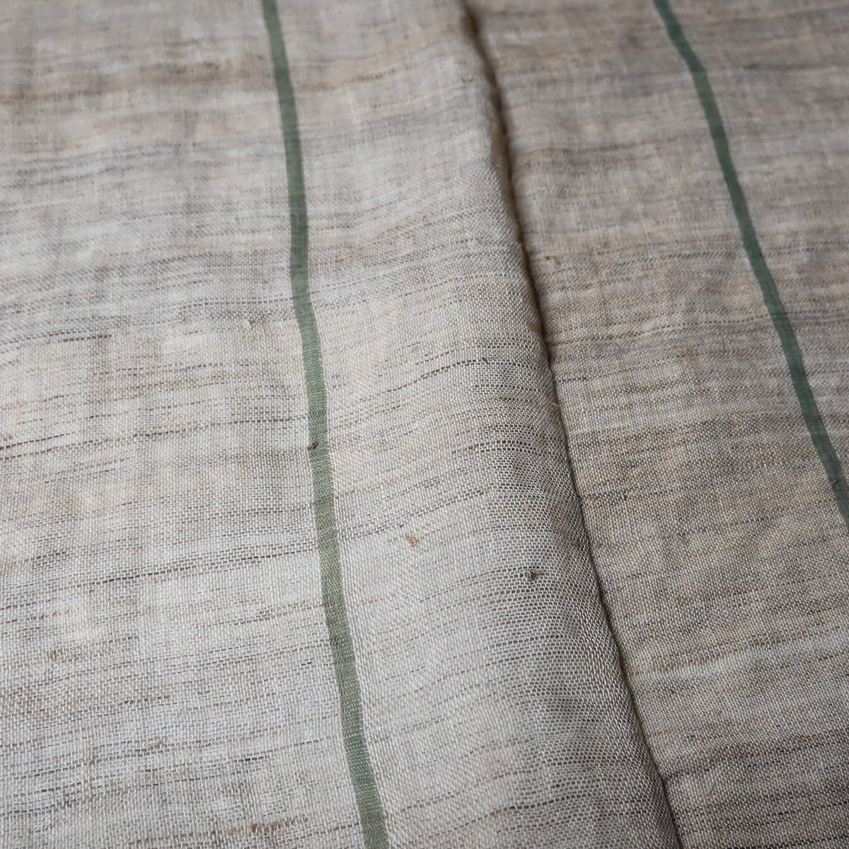 Detail of vintage three-panel mosquito net kaya hemp, natural with green stripes design.