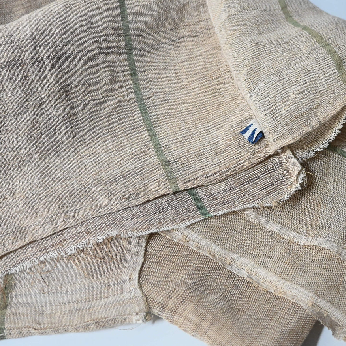 Detail of vintage three-panel mosquito net kaya hemp, natural with green stripes design.