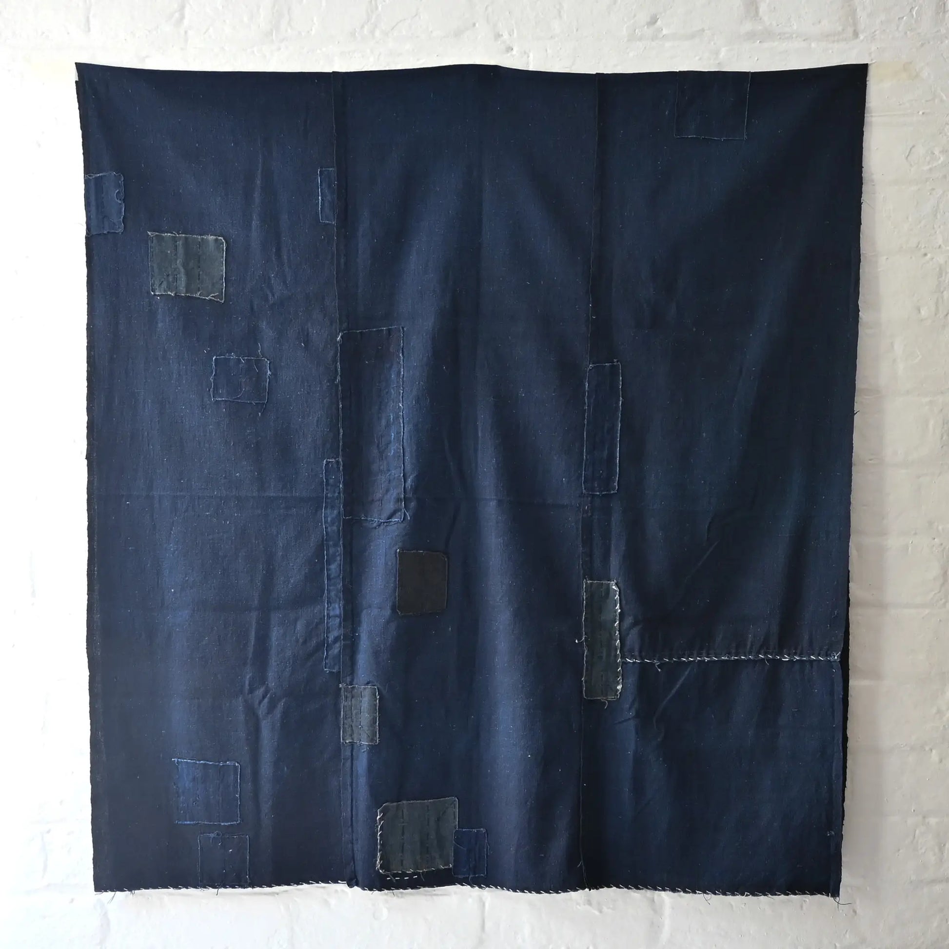 Full view of vintage Japanese three-panel plain indigo cotton futon cover with patches from the mid-20th century.