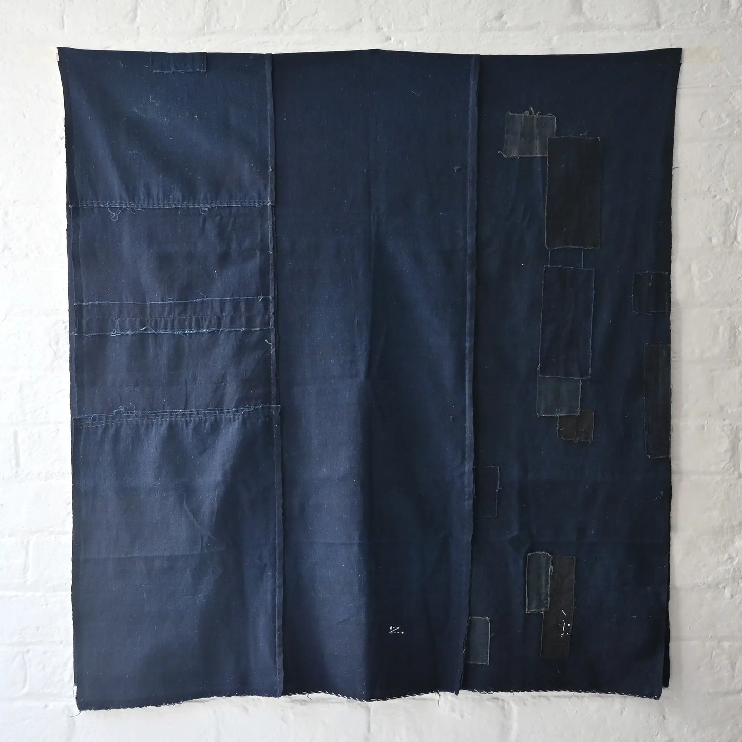 Full view of vintage Japanese three-panel plain indigo cotton futon cover with patches from the mid-20th century.