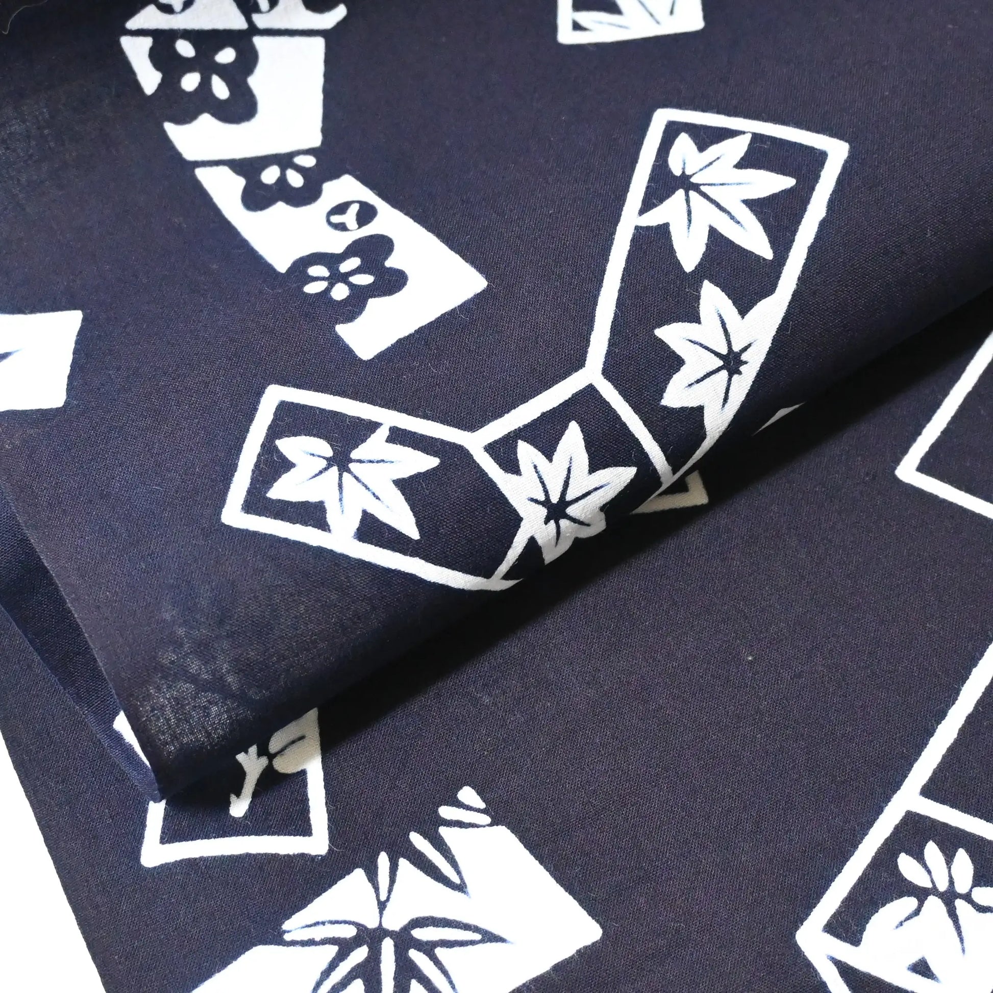 Vintage traditional yukata fabric rol with playful knot motifs filled with seasonal flowers.