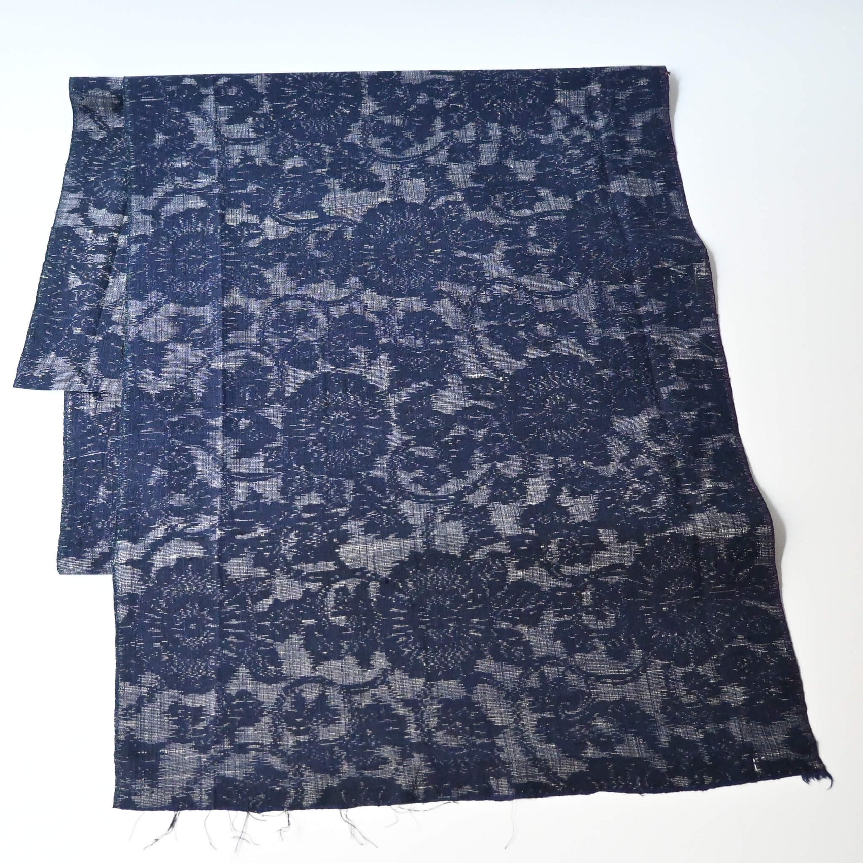 Vintage Japanese tsumugi kimono silk fabric piece with a classic chrysanthemum arabesque pattern.