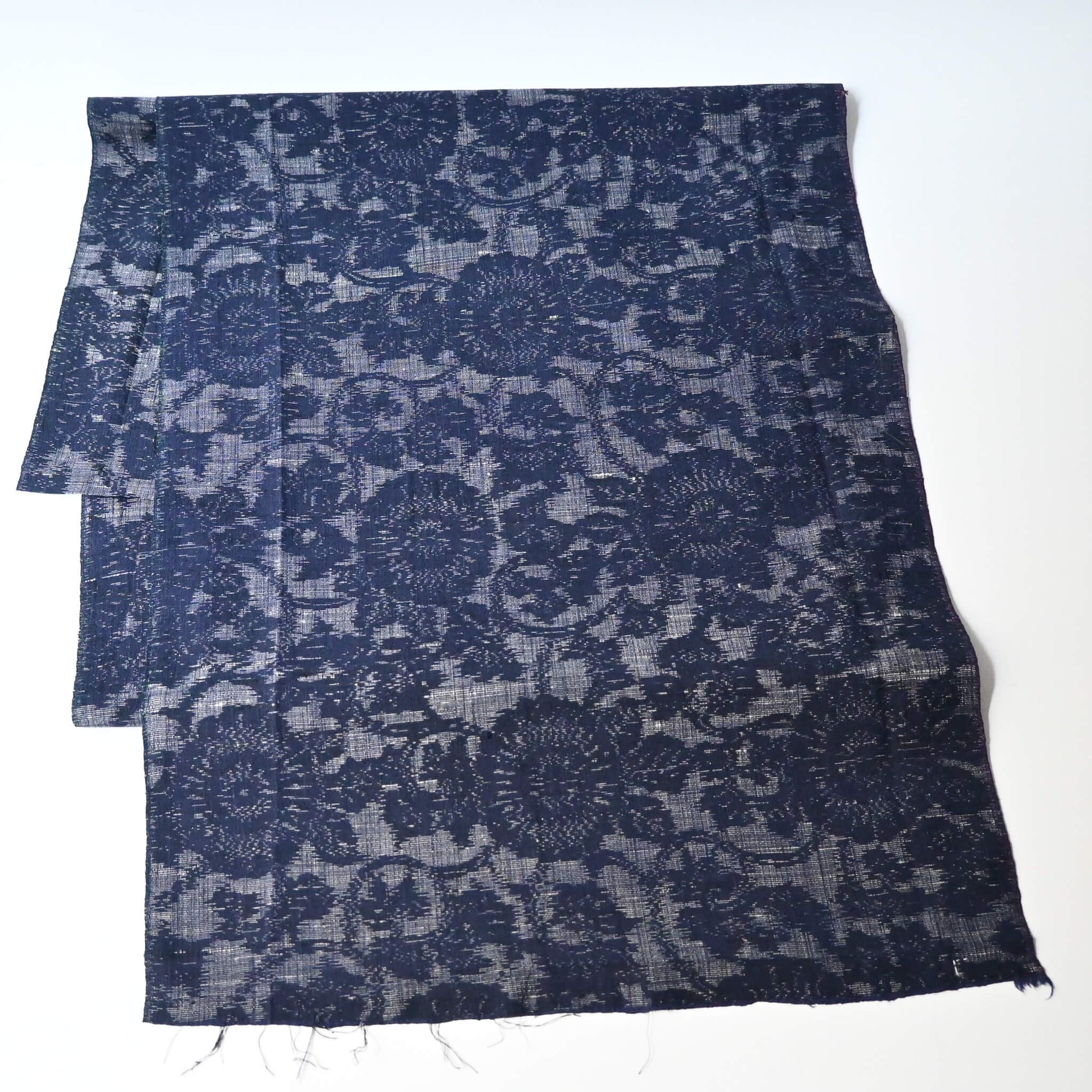 Vintage Japanese tsumugi kimono silk fabric piece with a classic chrysanthemum arabesque pattern.