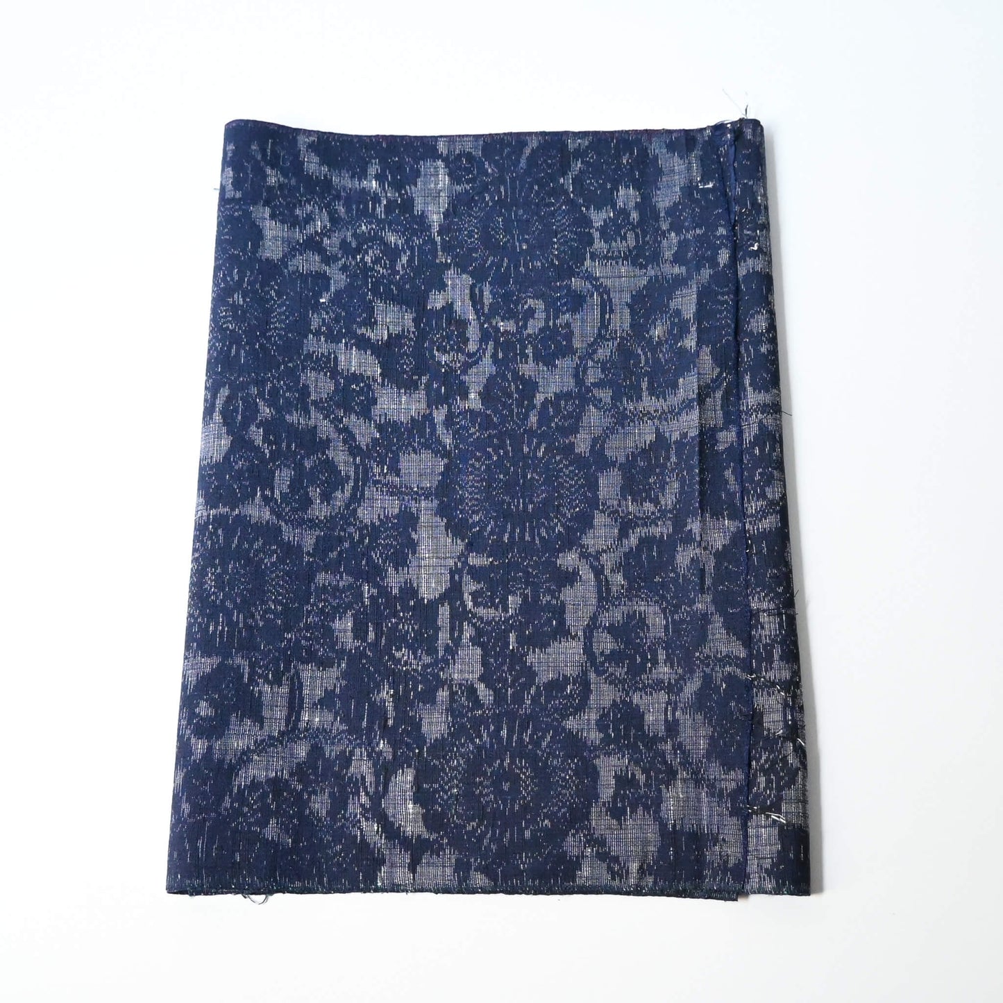 Vintage Japanese tsumugi kimono silk fabric piece with a classic chrysanthemum arabesque pattern.
