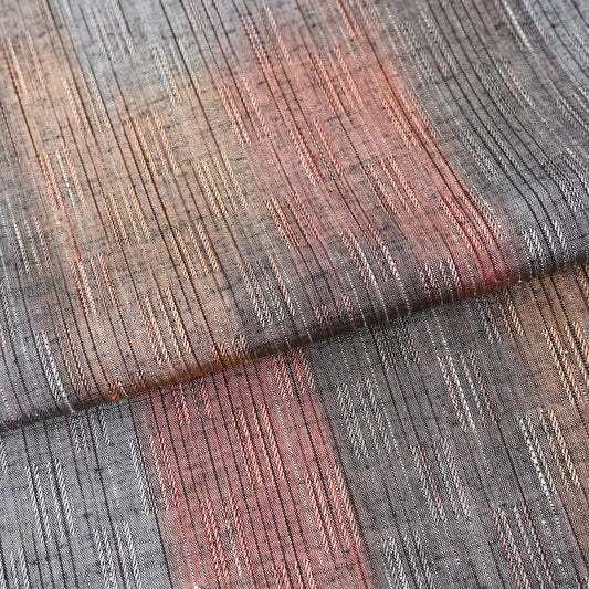 Detailed view of vintage tsumugi kimono silk piece with intricate woven design.