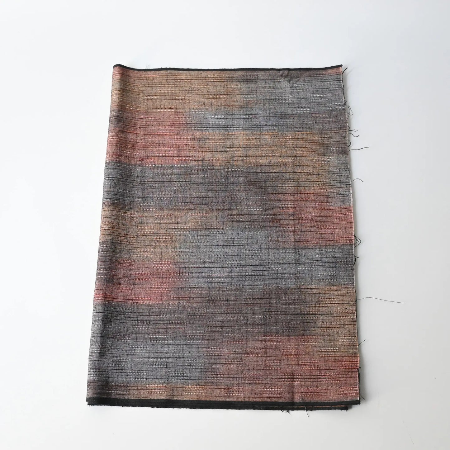 Vintage tsumugi kimono silk piece with intricate woven design.