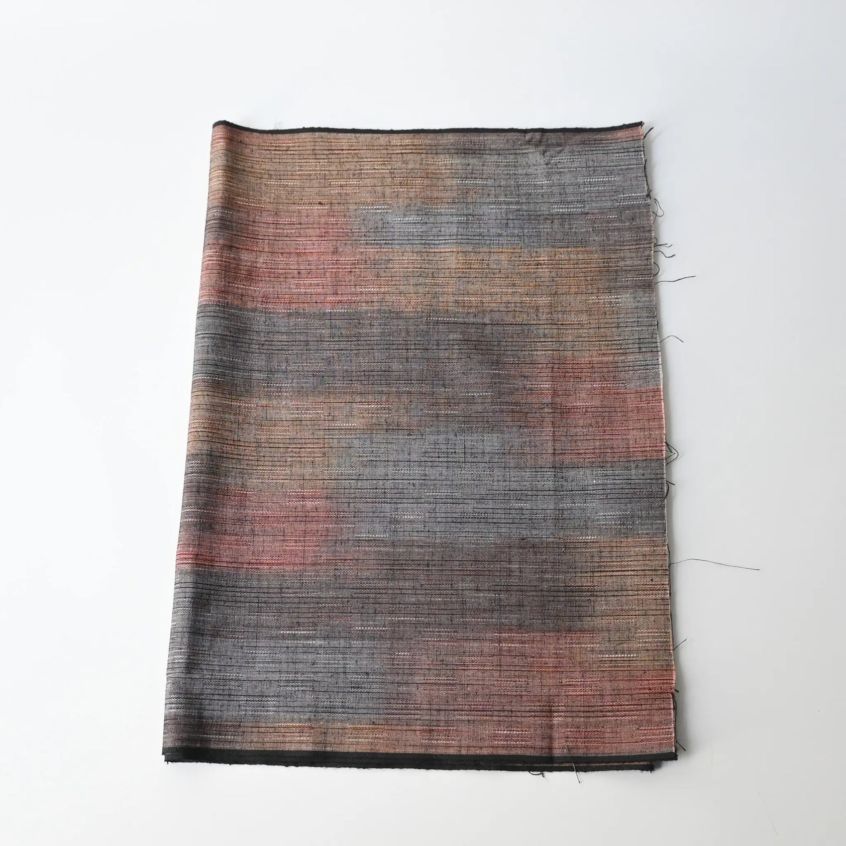 Vintage tsumugi kimono silk piece with intricate woven design.