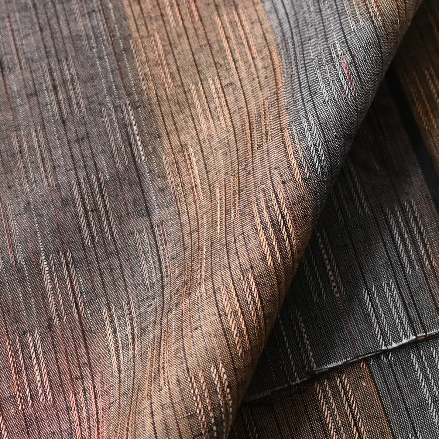 Detailed view of vintage tsumugi kimono silk piece with intricate woven design.