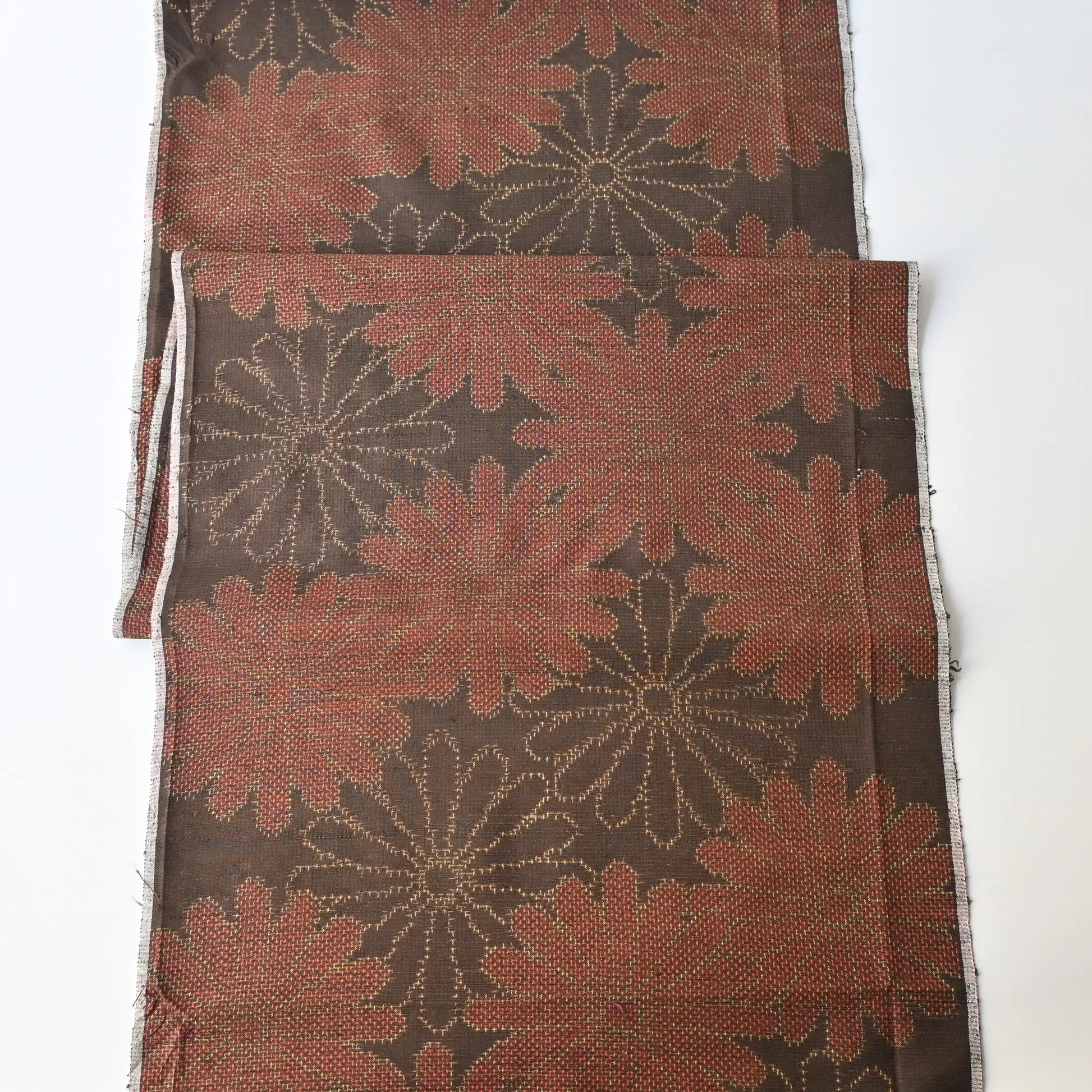Full view of vintage brown tusmugi kimono silk fabric piece with chrysanthemum motif.