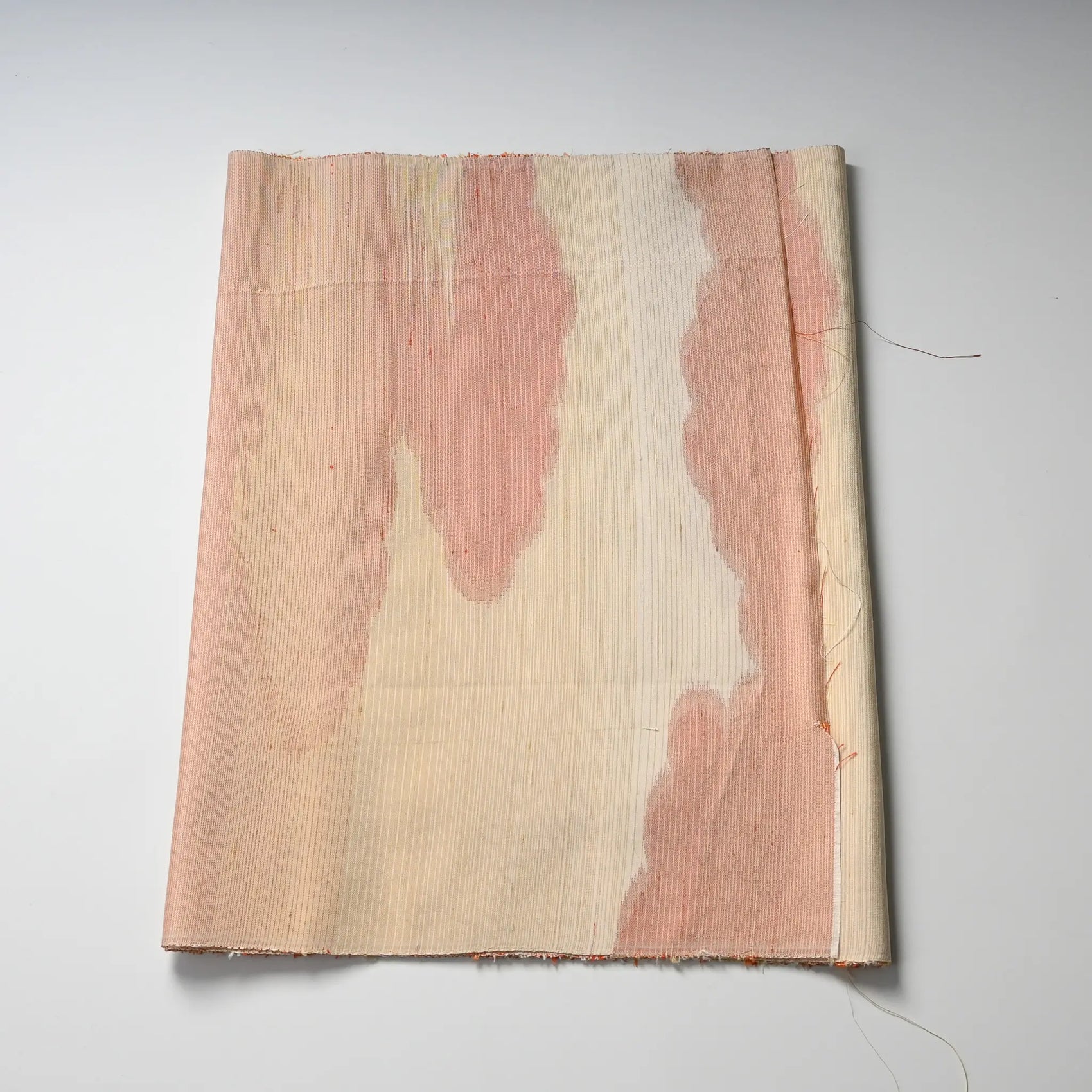 Vintage Tsumugi silk with cloud motif in soft orange and pink tones.