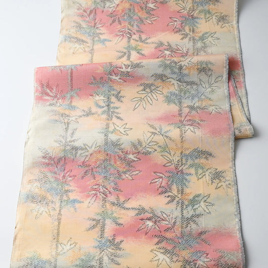 Full view of vintage tsumugi silk kimono fabric piece in soft yellow and pink with bamboo motif.