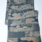 Vintage muted blue tsumugi silk kimono fabric piece with houses and chrysanthemum accents.