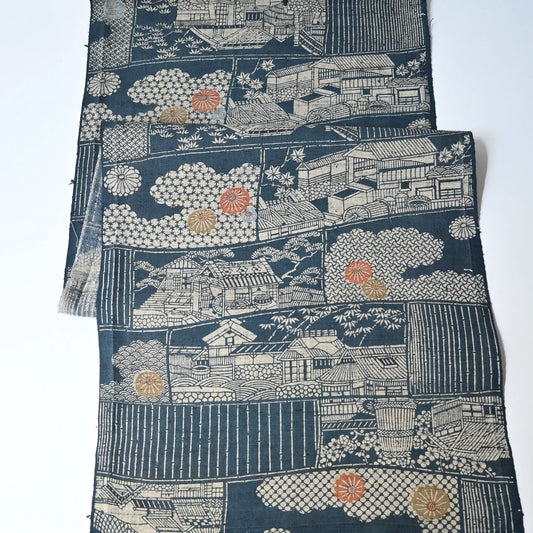 Vintage muted blue tsumugi silk kimono fabric piece with houses and chrysanthemum accents.