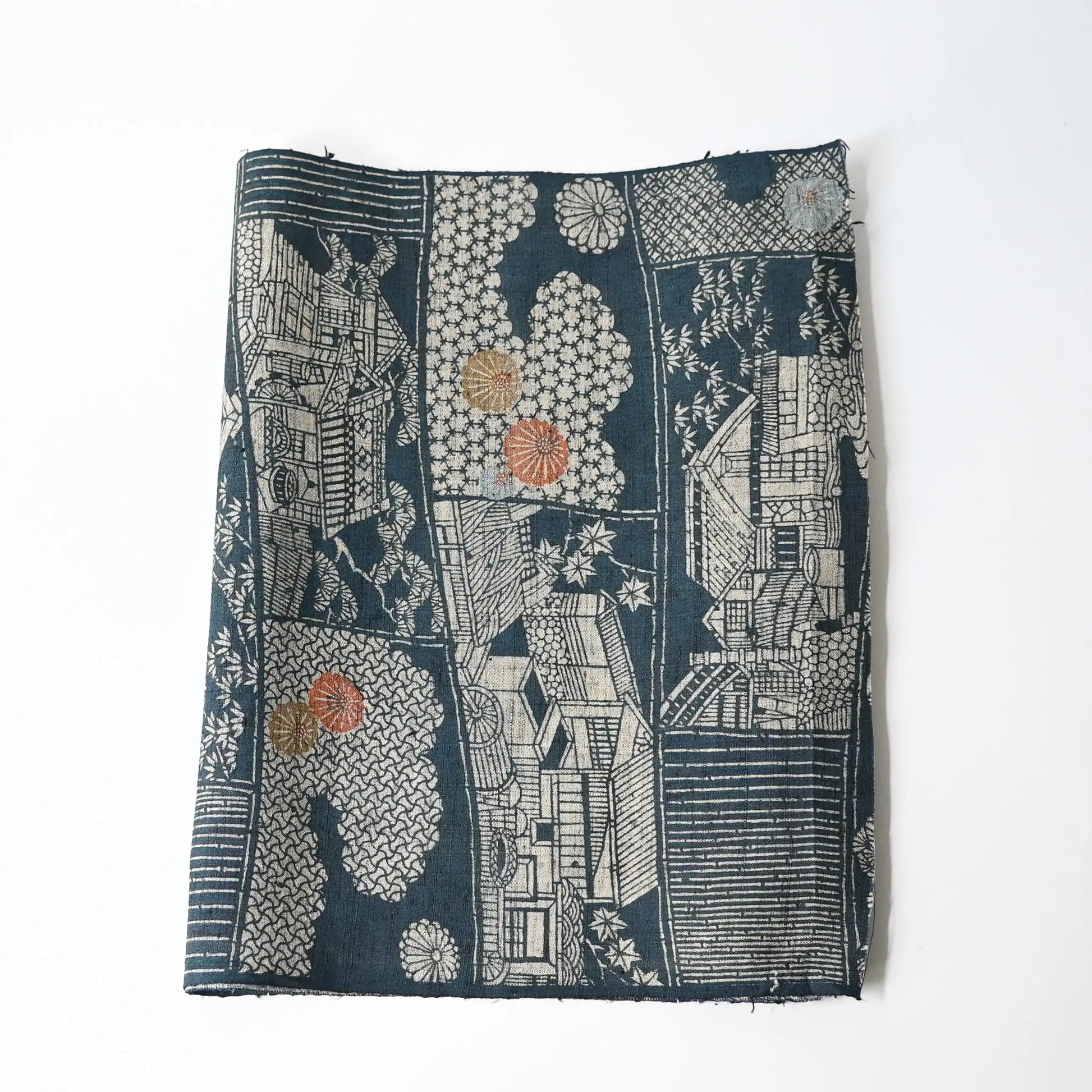 Vintage muted blue tsumugi silk kimono fabric piece with houses and chrysanthemum accents.