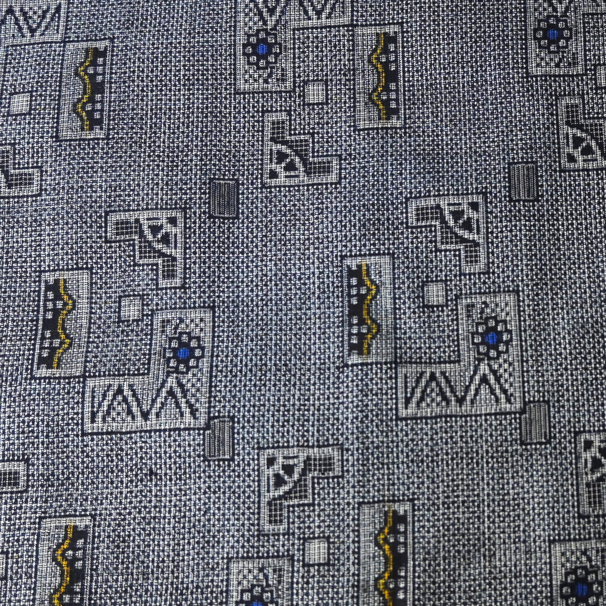 Detailed view of vintage tsumugi silk kimono fabric with intricate woven geometric pattern.